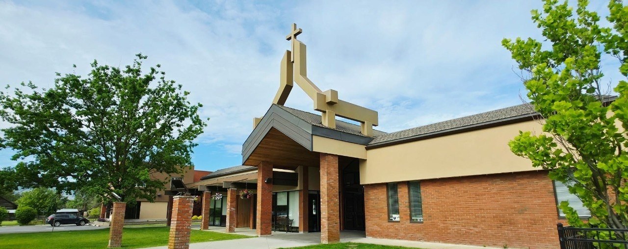 The front entrance of St. Charles Garnier Parish on a sunny spring morning
