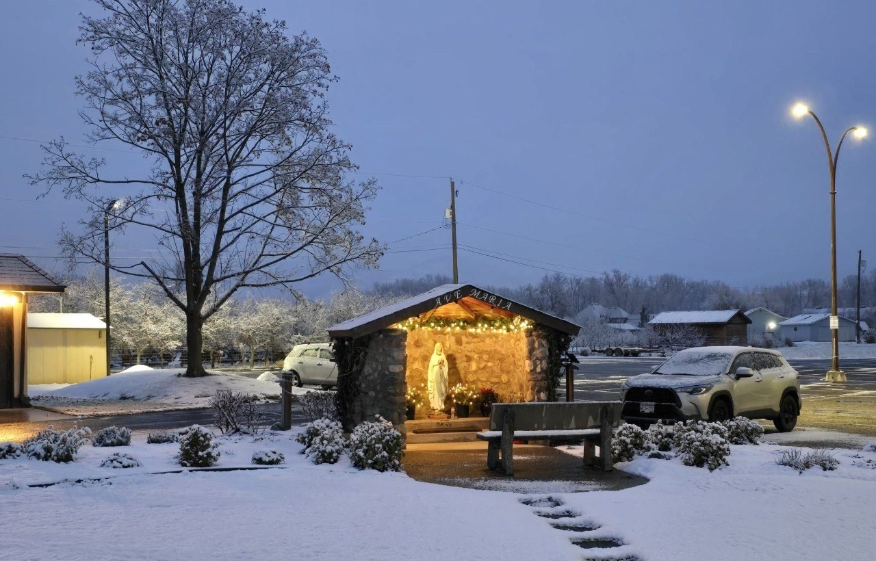 The Ave Maria grotto at the parish, lit on a winter evening